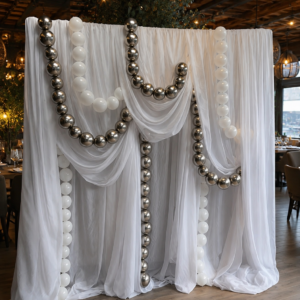Meta Title (SEO) Organizare Evenimente Constanța | Decor Restaurant cu Voal și Baloane Premium | Royal Flowers Meta Description Descoperă decoruri premium pentru organizare evenimente în Constanța. Royal Flowers realizează decor restaurant, panouri foto, decor nuntă, botez și aniversări cu montaj profesionist și design elegant. H1 Panou Decorativ Premium cu Voal și Baloane pentru Evenimente în Constanța Eleganță și rafinament pentru evenimentul tău Transformă orice restaurant, salon de evenimente sau locație privată într-un spațiu spectaculos cu ajutorul acestui panou decorativ premium cu voal și baloane, realizat exclusiv de Royal Flowers Constanța. Designul modern, inspirat din tendințele internaționale de event design, oferă un fundal elegant pentru fotografii și creează o atmosferă deosebită pentru invitați. Drapajele ample din voal alb, combinate cu ghirlandele din baloane albe și crom argintiu, creează un decor sofisticat, perfect pentru evenimente elegante organizate în restaurante, hoteluri sau săli de evenimente din Constanța. Acest panou este una dintre cele mai apreciate opțiuni pentru organizare evenimente Constanța, fiind ideal atât pentru evenimente private, cât și pentru cele corporate. Decor ideal pentru orice tip de eveniment Acest decor poate fi utilizat pentru: Nunți Botezuri Cununii civile Majorate Aniversări Petreceri private Evenimente corporate Lansări de produse Petreceri festive Ședințe foto Photobooth Indiferent de conceptul ales, panoul oferă un fundal elegant care pune în valoare fiecare moment important. Design premium realizat de Royal Flowers Constanța Fiecare decor este realizat cu atenție la detalii și adaptat spațiului în care este montat. Panoul include: ✔ Drapaje elegante din voal alb premium ✔ Ghirlande decorative cu baloane albe și crom argintiu ✔ Structură profesională și stabilă ✔ Design simetric și modern ✔ Aspect luxury pentru fotografii și filmări ✔ Montaj și demontaj realizate de echipa Royal Flowers De ce să alegi Royal Flowers? Royal Flowers nu este doar o florărie în Constanța, ci un partener complet pentru decorul evenimentului tău. Pe lângă buchete și aranjamente florale premium, realizăm decoruri personalizate pentru restaurante, saloane și locații private, folosind materiale de calitate și cele mai noi tendințe în event design. Serviciile noastre includ: Organizare evenimente Constanța Decor nuntă Constanța Decor botez Constanța Decor restaurant Constanța Panouri foto Arcade cu baloane Decor floral Aranjamente florale premium Închiriere decor evenimente Montaj și transport Potrivit pentru restaurante și saloane din Constanța Acest panou decorativ este conceput pentru a fi amplasat în restaurante și săli de evenimente, devenind punctul principal al încăperii. Poate fi poziționat în spatele mesei de prezidiu, în zona candy bar, lângă tort sau într-un spațiu dedicat fotografiilor. Aspectul elegant și culorile neutre permit integrarea în orice tematică de eveniment. Comandă decorul tău premium Dacă îți dorești un decor elegant și memorabil pentru evenimentul tău, echipa Royal Flowers Constanța îți oferă consultanță, transport, montaj și personalizare completă. Vizitează www.royalflowers.ro sau showroom-ul nostru din Constanța pentru a descoperi cele mai noi colecții de decoruri pentru evenimente, aranjamente florale și baloane premium. URL recomandat https://www.royalflowers.ro/decor-restaurant-voal-baloane-constanta SEO Title alternativ Decor Restaurant Constanța | Organizare Evenimente Constanța | Royal Flowers Alt Text Imagine Panou decorativ premium cu voal alb și baloane crom argintiu montat într-un restaurant pentru organizare evenimente în Constanța. Cuvinte cheie SEO organizare evenimente Constanța, decor evenimente Constanța, decor restaurant Constanța, decor nuntă Constanța, decor botez Constanța, decor baloane Constanța, panou foto Constanța, panou decorativ Constanța, florărie Constanța, Royal Flowers Constanța, aranjamente florale Constanța, decor sală evenimente Constanța, decor premium Constanța, închiriere decor evenimente Constanța, decor candy bar Constanța, decor prezidiu Constanța. Recomandare SEO: deoarece acest produs face parte dintr-o categorie diferită față de florărie, este indicat să îl încadrați într-o categorie dedicată, de exemplu „Decor Evenimente Constanța” sau „Organizare Evenimente Constanța”. Astfel, pagina are șanse mai mari să se poziționeze în Google atât pentru căutările legate de decor și organizare evenimente, cât și să consolideze autoritatea domeniului Royal Flowers pe această nișă.